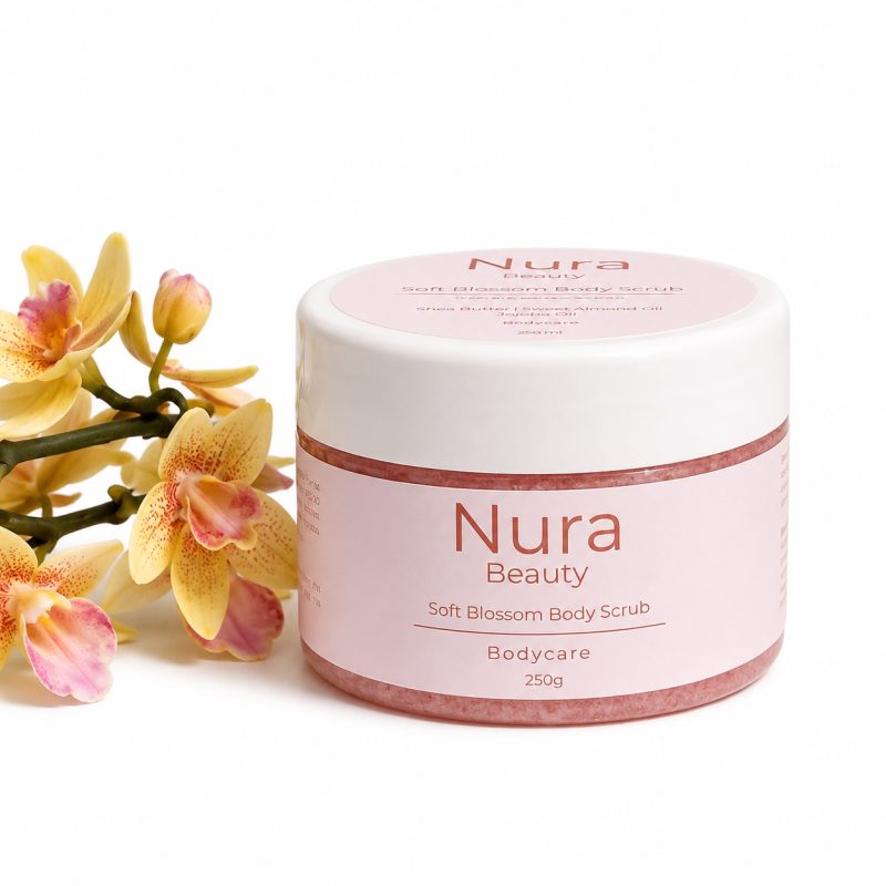 Nura Beauty Soft Blossom Body Scrub, a 250g jar, beside yellow and pink orchids